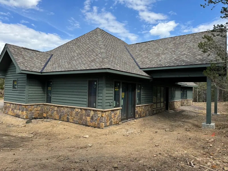 Green painted exterior with stone wainscot