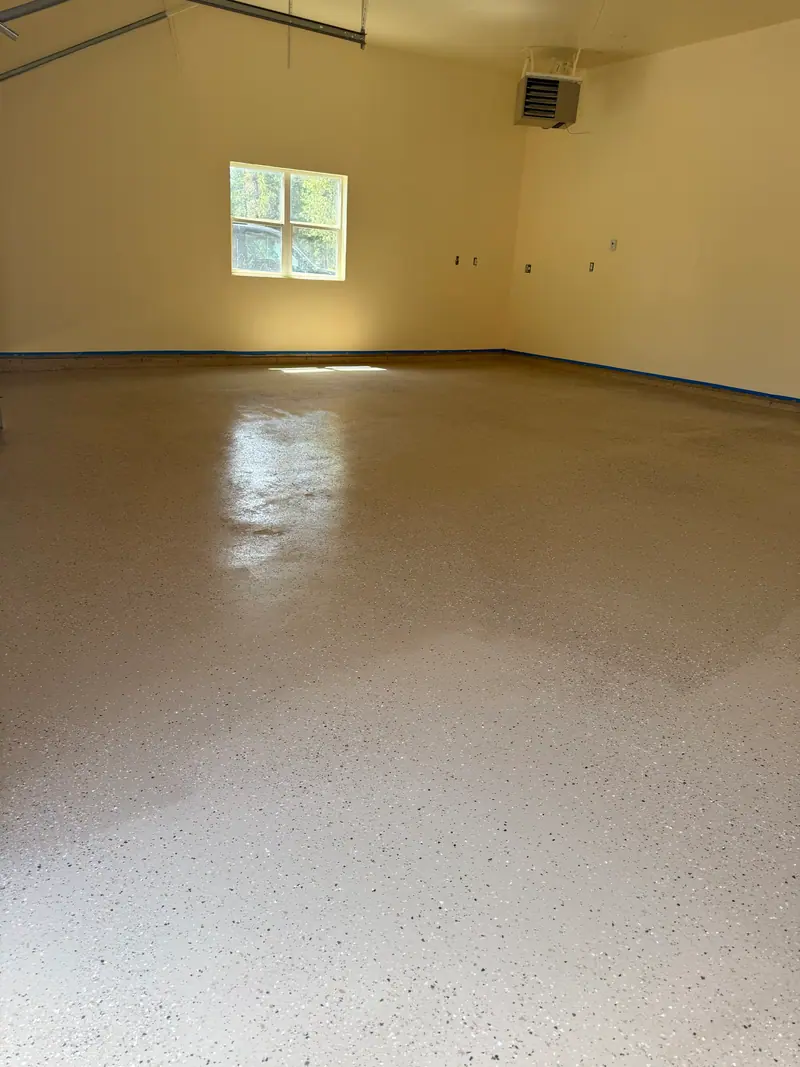 Garage floor finished with a speckled epoxy coating