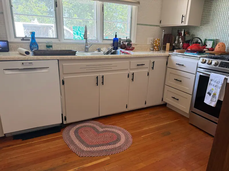 Bright white kitchen cabinets after professional refinishing
